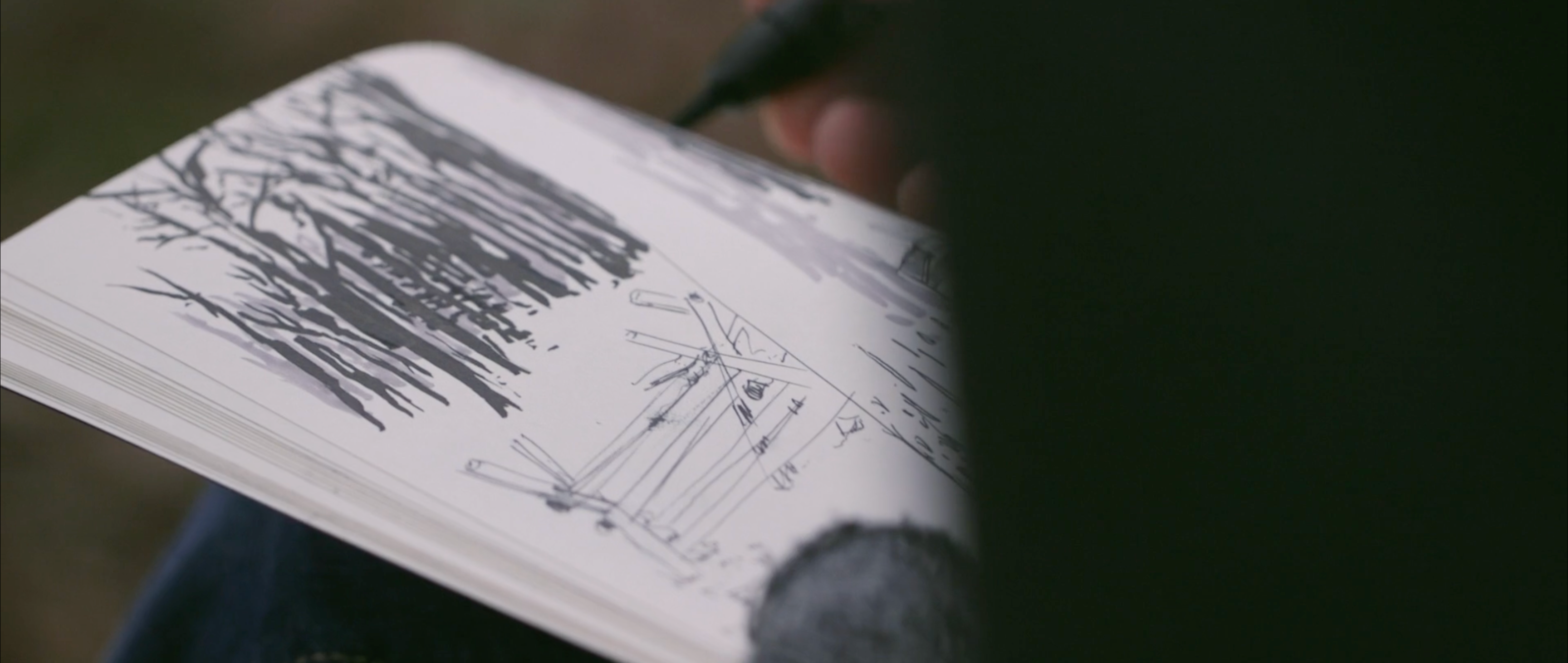 Jared Boggess drawing in a sketchbook